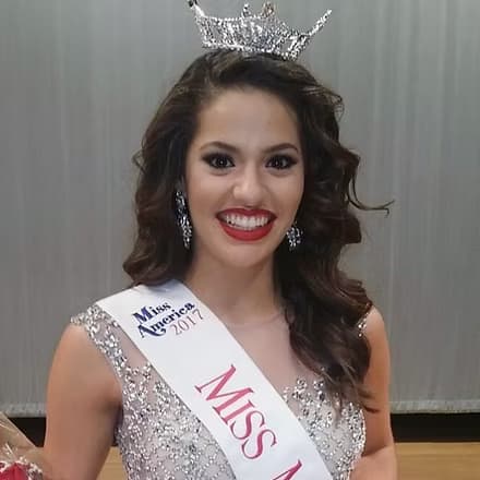 Stephanie Almeida, Miss Miami 2017, on stage in evening gown.